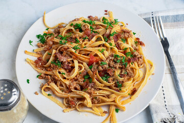 linquine  top with crumble  sausage, bacon  bits and parsley