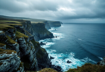 Coastal cliffs overlooking a blue ocean with white clouds in the sky, surrounded by lush green vegetation