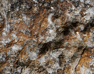 Empty rough brown and grey natural stone wall on cave for abstract background and texture. beautiful patterns, space for work, banner, seamless wallpaper close up.