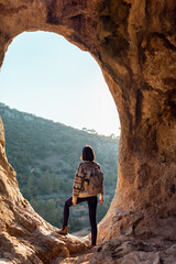 Woman in the mountains. Girl traveling in the mountains. Trekking and hiking. Girl with a backpack.