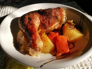 Chicken with potatoes and garlic roasted in wood oven
