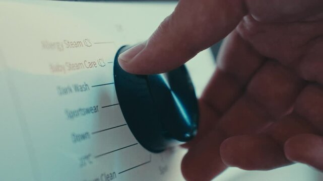 close up turning on washing machine