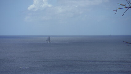 Beautiful picture of a sailboat on the sea in the horizon, during a lovely summer day in...