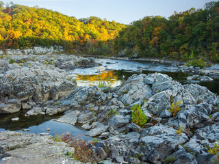 Hikers on Rocks on the River