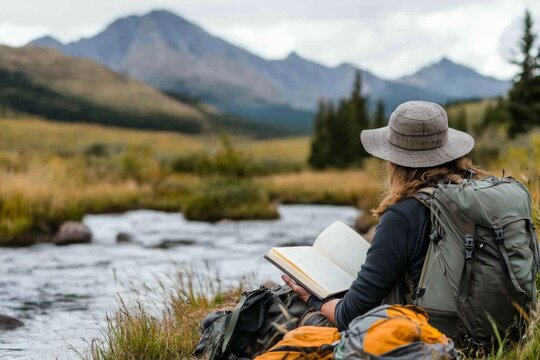 A backpacker resting by a tranquil stream, with their gear spread out and a journal open in their lap