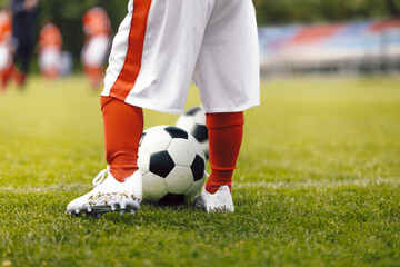 Little Kids Soccer Football Game. Legs of Child Playing Soccer on Grass Pitch. Children in Football Club in a Tournament
