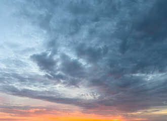 Colorful sunset sky with clouds over tranquil landscape during evening