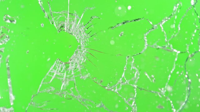 Super slow motion of gunshot through the glass, shattering against green screen background . Filmed on high speed cinema camera, 1000 fps.