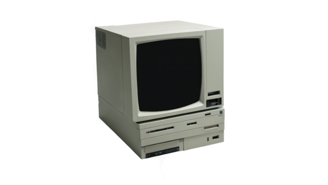An old-school computer system with a monochrome screen, floppy disks, and a large, boxy CPU, all set against a transparent background.