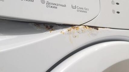 Rust on the washing machine body. Breakdown of household appliances