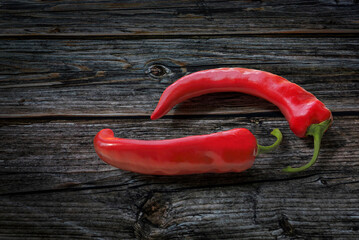 Red chili pepper on wooden background.
