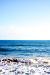 Texture of blue turquoise water  in the sunlight and a sea of waves and bubbles