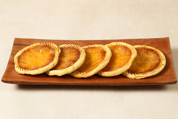 Delicious Golden Brown Mini Pies on Wooden Tray