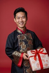 Fototapeta premium a asian man holding a gifts box with traditional