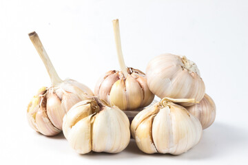 Close-up of Fresh Garlic Bulbs on White Background