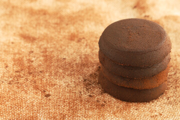 Stack of used coffee pucks, closeup, copy space