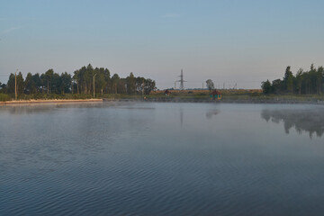 Naklejka premium Sunrise over the lake. Fishing on the lake. Reflection in water.