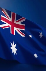 Flag of Australia on a flagpole vertical light blue background. Festive concept of national unity of the country on Australia Day