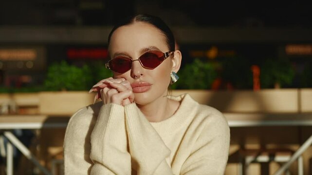 A black-haired girl of Asian appearance is sitting at the table.
A spectacular brunette with earrings on her ears and a piercing in her nose is sitting at the table.
Young and successful girl