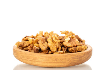 Shelled walnuts on a wooden plate, close-up, isolated on a white background.