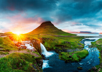 Vibrant sunset over volcanic Kirkjufell mountain and dramatic sky in summer at Snaefellsnes peninsula, Iceland