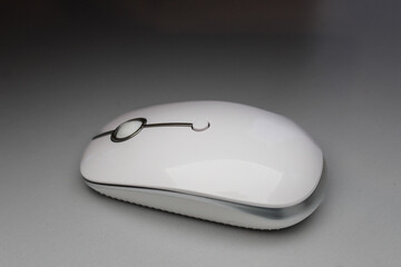 white slim wireless computer mouse isolated on dramatic technology modern presentation white background