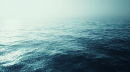 Obraz premium Serene Seascape with Gentle Waves Under a Soft Misty Sky, Capturing the Tranquility of the Ocean's Surface at Dawn or Dusk for a Dreamy Atmosphere