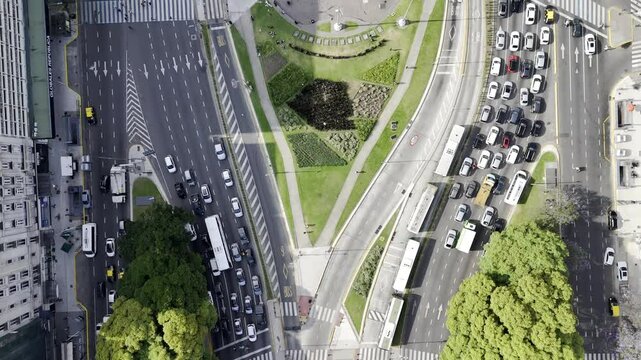 Drone flies north with camera pointing down, over the obelisk at Plaza de la Republica on Avenida 9 de Julio in Buenos Aires, Argentina