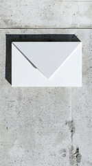 White envelope form affixed to a textured gray wall.