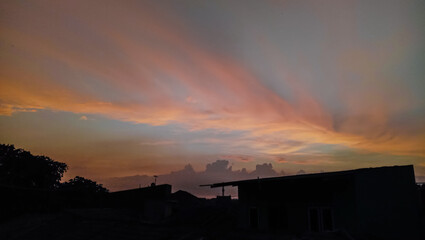 A sunset sky colored by the light of the setting sun in mixed colors, blue and orange. Bright, warm and charming.