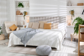 Comfortable large bed in beautiful room. Interior design