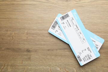Travel agency. Flight tickets on wooden table, top view. Space for text