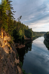 eagle cliffs near Cēsis on a sunny summer evening after rain with a reflection in the river.