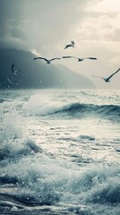 Obraz premium Seagulls Flying Over Turbulent Waves at the Ocean Shoreline