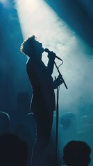 Silhouette of Singer Performing on Stage with Dramatic Lighting