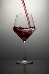 red wine pouring into glass