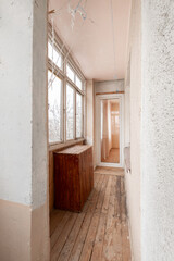 Bright Enclosed Home Balcony with Wooden Floor and Paneling in Apartment Building. Old Soviet Style Home Interior