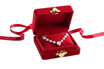 Valentine Day: A sparkling diamond necklace displayed in a red velvet box with a heart-shaped clasp, isolated on a white background.