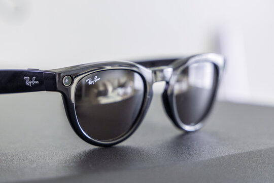 Close-up of black Meta Ray-Ban smart glasses featuring a camera lens and sleek, reflective lenses.