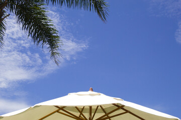 Parasol with blue sky in the background on a beautiful summer day