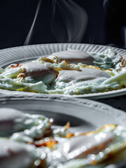 hot fried eggs on white plates