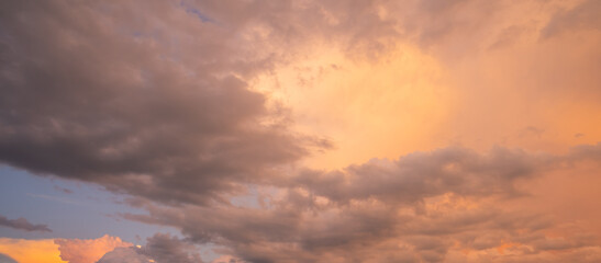 Sunset background. Dramatic sunset. Sky with clouds in sunset sky light background. Sunrise with clouds dawn sky. Calm sunset sky and sun through clouds over.