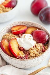 Obraz premium healthy breakfast bowl with caramelized plums, quinoa crumble, and a dollop of creamy yogurt, served in a speckled ceramic bowl, fresh and nourishing mood