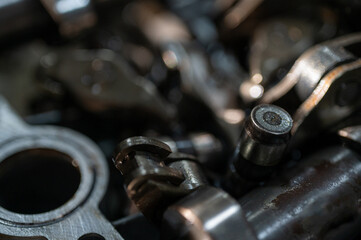 Close-up view of industrial metal gears in motion, symbolizing engineering, machine building, machine construction and precision manufacturing, disassembled car engine, spare parts. Selective focus