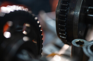 Close-up view of industrial metal gears in motion, symbolizing engineering, machine building,...