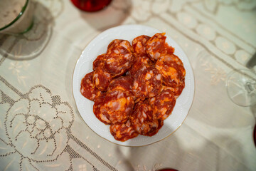 Close-up of sliced paio sausage on a festive dinner table, ready for a celebration. Perfect for food, party, and gourmet themes.