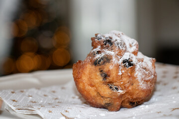 Oliebol fresh Dutch pastry on plate festive tissue. New years treat in the Netherlands. Happy New...