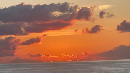 Naklejka premium Dramatic Sky Moments Before Sunrise Over Calm Ocean