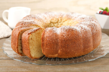 Freshly baked sponge cake on wooden table, closeup