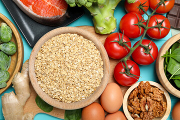 Different fresh products rich in melatonin on light blue table, flat lay